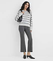 A woman wearing a grey striped sweater, dark grey trousers, and black heels stands against a plain white background. carousel Product Image 2
