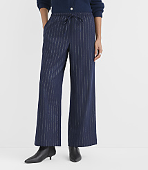 A person wearing navy blue pinstriped wide-leg pants and black pointed-toe heels stands against a plain white background. carousel Product Image 2