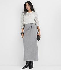 A woman wearing a white knit sweater and a long grey skirt stands against a plain white background. carousel Product Image 1