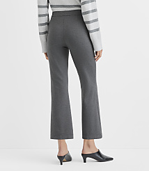 A person wearing a grey striped sweater, charcoal grey cropped trousers, and black mules stands against a plain white background. carousel Product Image 4