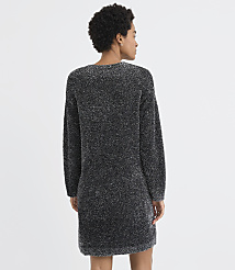 A woman with curly hair stands with her back to the camera wearing a shimmering dark grey knit dress against a plain white background. carousel Product Image 3
