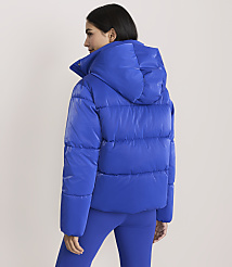 A woman wearing a bright blue puffer jacket and matching leggings stands against a plain, light-colored background. carousel Product Image 3