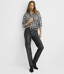 A woman wearing a black and white checkered shirt and black faux-leather pants stands against a plain white background. carousel Product Image 2