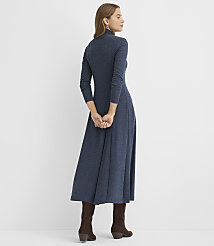 A woman wearing a long-sleeved navy blue maxi dress and brown boots stands with her back to the camera against a plain white background. carousel Product Image 3