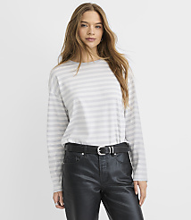 A woman wearing a striped white and grey long-sleeved shirt and black leather pants stands against a plain white background. carousel Product Image 1