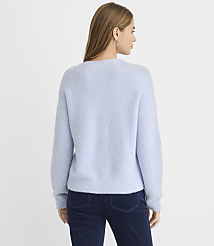 A woman wearing a light blue fuzzy sweater and dark blue corduroy pants stands against a plain white background. carousel Product Image 3