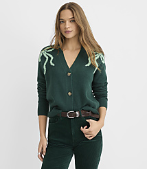 A woman wearing a dark green cardigan with light green accents and matching corduroy pants stands against a plain white background. carousel Product Image 1