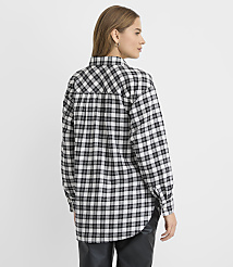A woman wearing a black and white plaid shirt and black leather pants stands against a plain white background. carousel Product Image 3