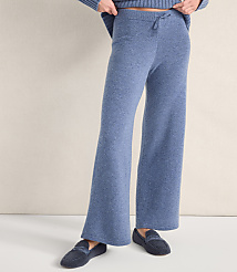 A person wears blue wide-leg knit pants and dark blue slippers against a plain, light-colored wall. carousel Product Image 2
