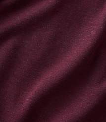 A close-up of maroon fabric with soft folds in the foreground and a slightly blurred texture in the background. carousel Product Image 4