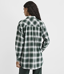 A woman wearing a green and white plaid shirt stands with her back to the camera against a plain white background. carousel Product Image 3