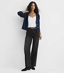 A woman wearing a navy cardigan, white top, and black wide-leg jeans stands against a plain white background. carousel Product Image 2