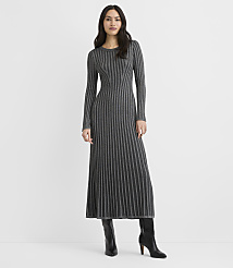 A woman wearing a long-sleeved, ribbed grey maxi dress and black boots stands against a plain white background. carousel Product Image 2