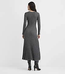 A woman wearing a long-sleeved, ribbed grey maxi dress and black heeled boots stands with her back to the camera against a plain white background. carousel Product Image 3