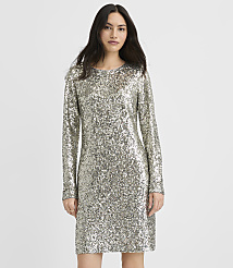 A woman wearing a long-sleeved silver sequin dress stands against a plain white background. carousel Product Image 1