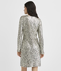 A woman wearing a long-sleeved silver sequin dress stands with her back to the camera against a plain white background. carousel Product Image 3