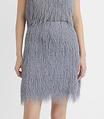 A person wears a grey shaggy faux-fur dress against a plain white background. carousel Product Image 2