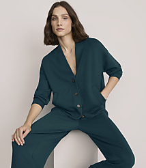 A woman wearing a dark teal matching set poses against a plain, light-colored background. carousel Product Image 2