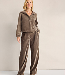 A woman wearing a brown velvet two-piece lounge set stands against a plain, light-colored wall. carousel Product Image 2