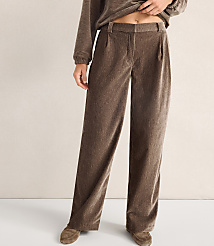 A person wears brown wide-leg trousers and a matching top against a plain, neutral-colored wall. carousel Product Image 2