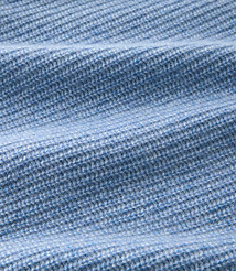 A close-up of light blue ribbed knit fabric with soft folds in the foreground and a blurred texture in the background. carousel Product Image 3