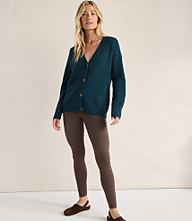 A woman wearing a dark teal cardigan and brown leggings stands against a plain, light-colored background. carousel Product Image 2