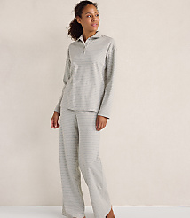 A woman wearing a grey striped pajama set stands against a plain, light-colored wall. carousel Product Image 2