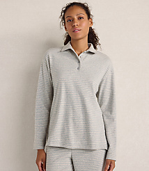 A woman wearing a grey striped long-sleeved polo shirt and matching pants stands against a plain, neutral-colored wall. carousel Product Image 1