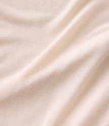 Soft, cream-colored fabric with gentle folds in the foreground and a smooth, consistent texture in the background. carousel Product Image 3