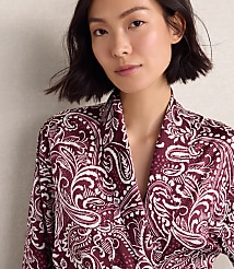 A woman wearing a maroon and white paisley print robe stands against a plain, light-colored wall. carousel Product Image 2