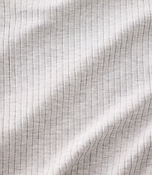 White ribbed fabric with soft folds and shadows fills the entire frame. carousel Product Image 3