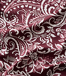 Intricate white and light pink floral and paisley patterns swirl across a deep burgundy fabric with soft folds. carousel Product Image 4