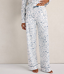 A person wears white pajama pants with a blue marble print against a plain, neutral-colored wall. carousel Product Image 2