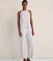 A woman wearing a light grey ribbed sleeveless top and matching wide-leg pants stands against a plain, neutral-toned wall. carousel Product Image 1