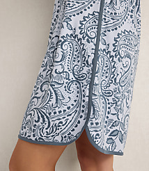 A person wears a blue and white paisley print skirt against a plain, light-colored background. carousel Product Image 2