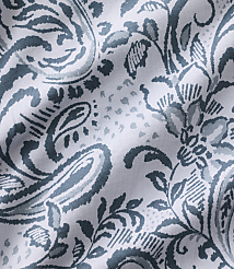 Blue and grey paisley and floral patterns are printed across a white, wrinkled fabric background. carousel Product Image 4