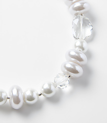 A string of white pearls and clear faceted crystals curves across a plain white background. carousel Product Image 2