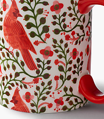 A white mug features a pattern of red cardinals and green foliage against a plain white background. carousel Product Image 3