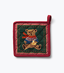 A red quilted pot holder featuring a teddy bear in a sweater and scarf sits against a plain white background. carousel Product Image 2