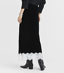A person wearing a long black velvet skirt with white lace trim and black boots stands against a plain white background. carousel Product Image 3