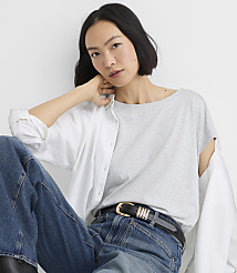 A smiling woman in a denim skirt and jacket stands against a plain white background. carousel Product Image 2