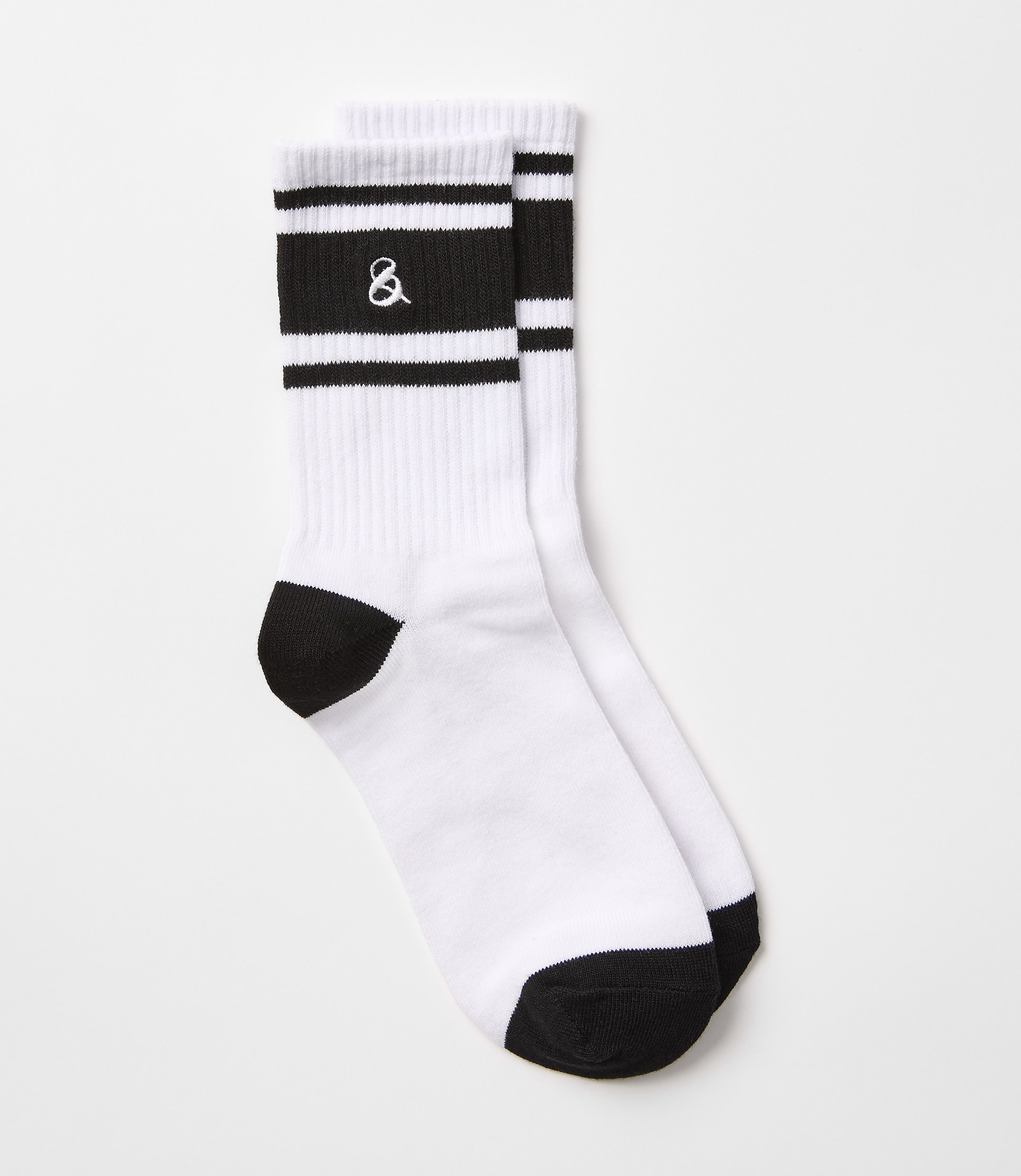 A pair of white crew socks with black stripes and an ampersand logo are laid out against a plain white background.