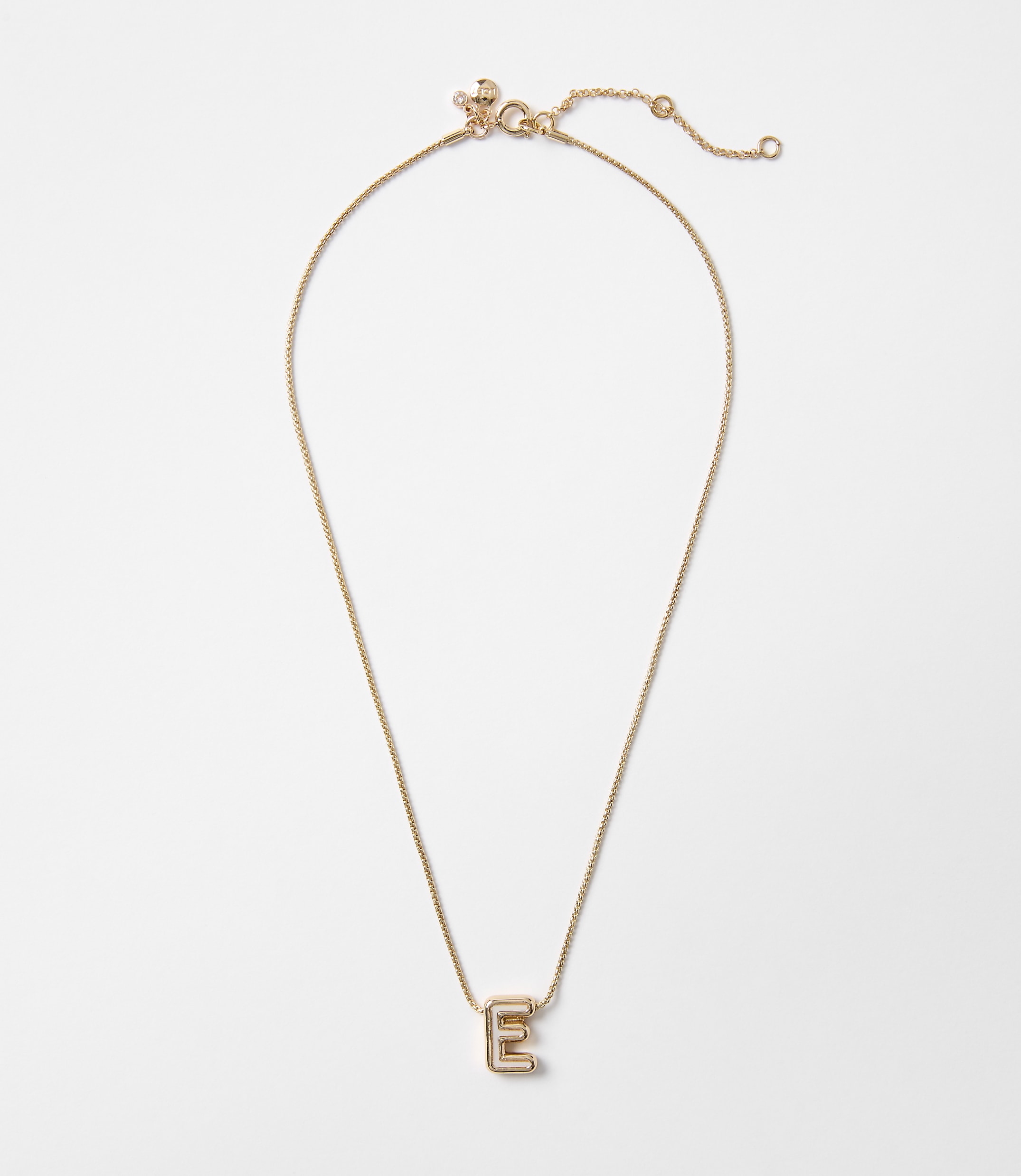A delicate gold necklace with an "E" pendant rests on a plain white background.