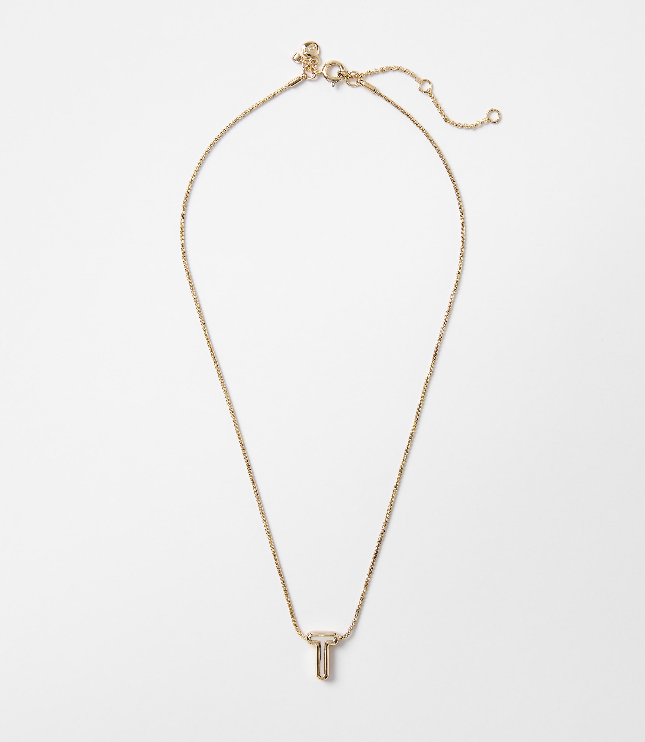 A delicate rose gold necklace with a "T" pendant hangs against a plain white background.