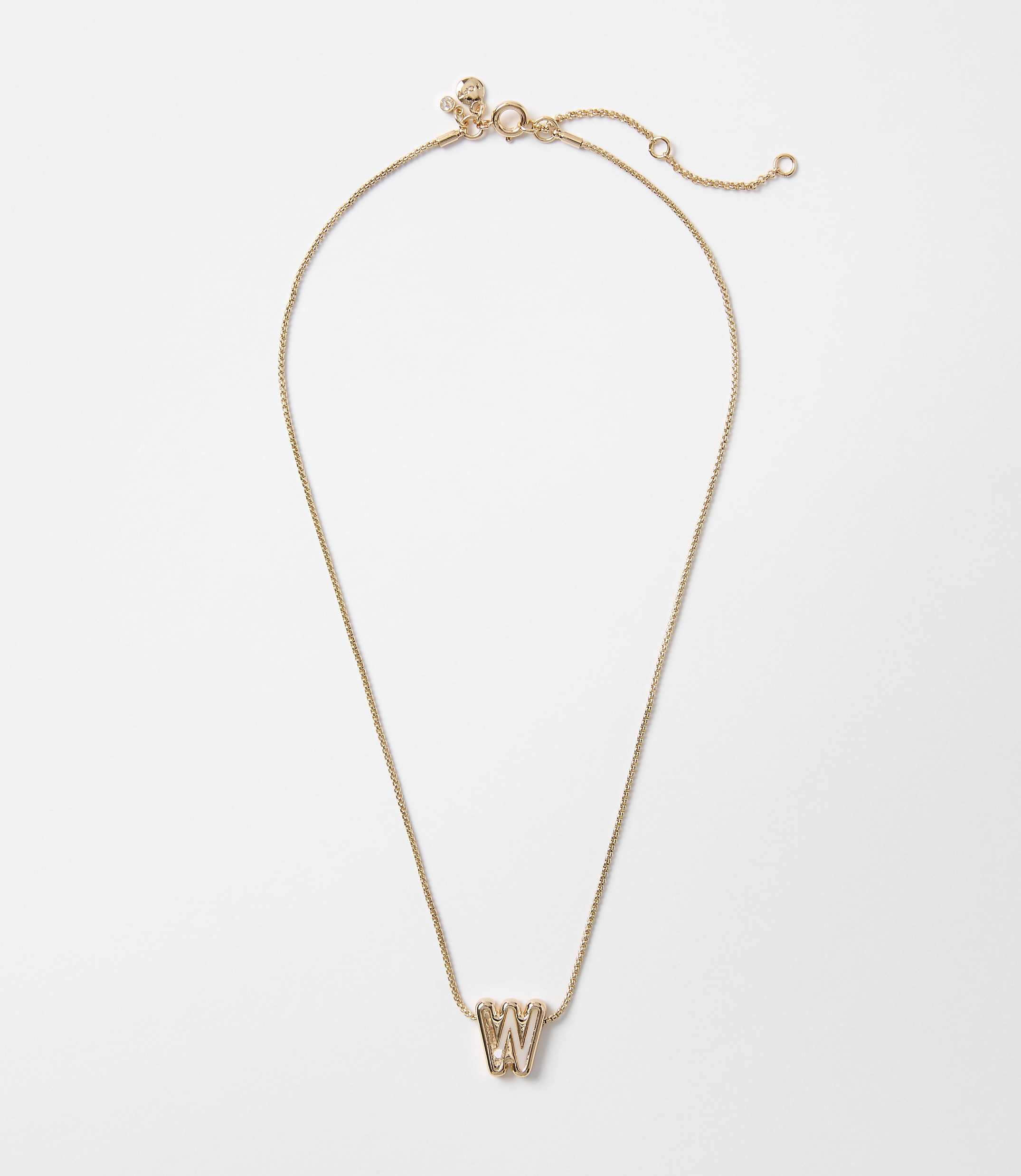 A delicate rose gold necklace with a "W" charm hangs against a plain white background.