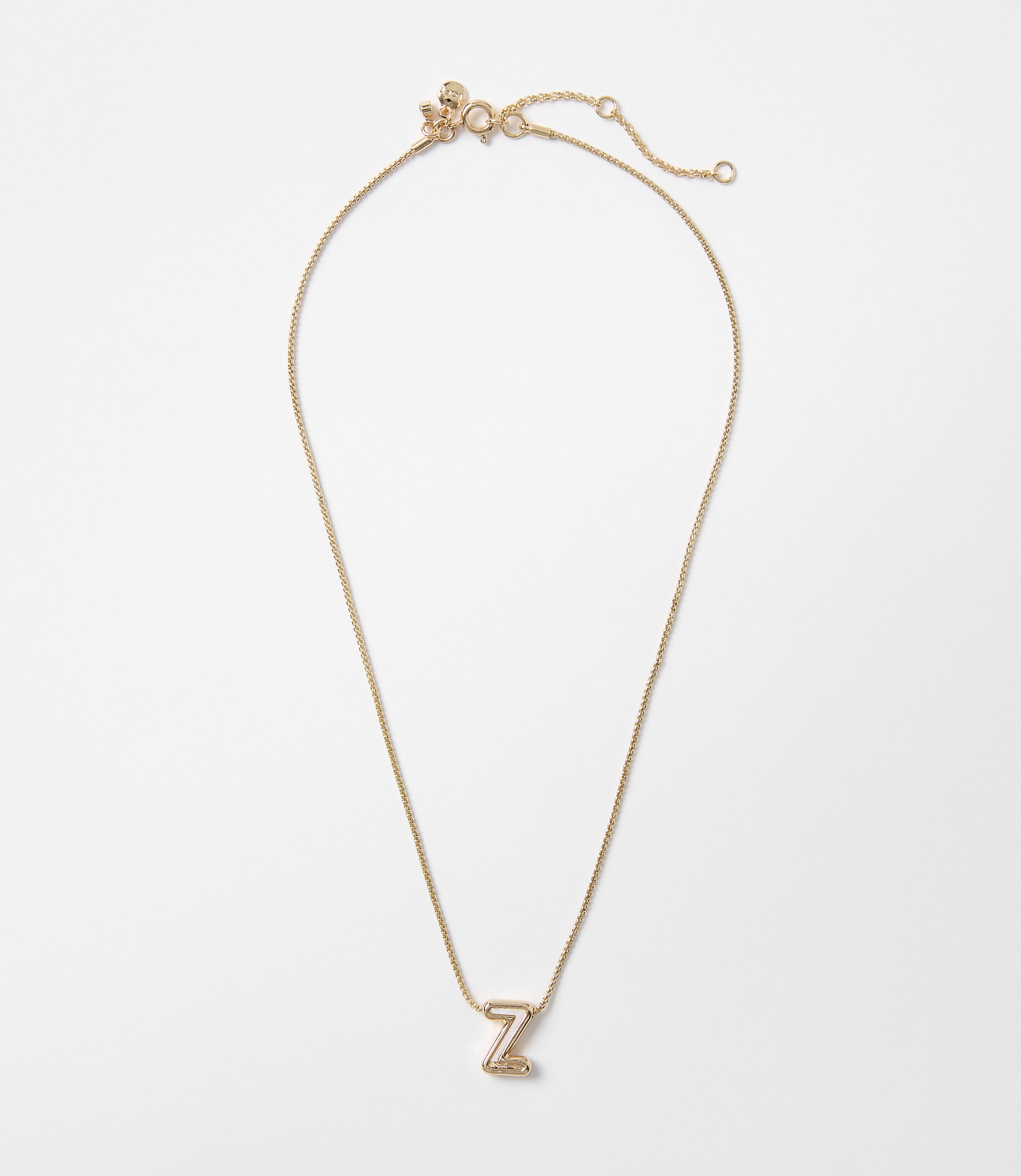 A delicate rose gold necklace with a letter "Z" pendant rests on a plain white background.
