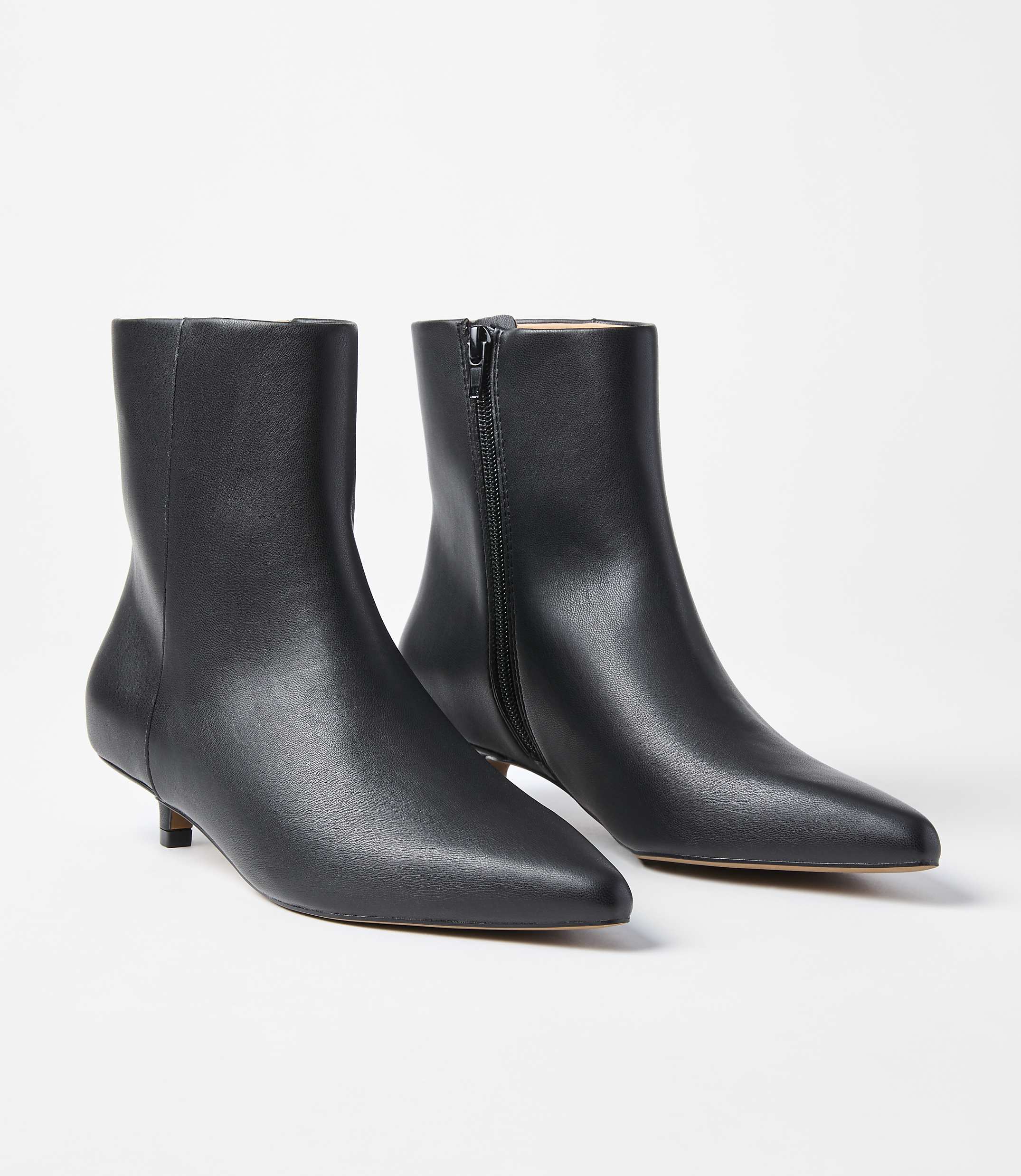 A pair of black leather kitten heel ankle boots with pointed toes are displayed against a plain white background.