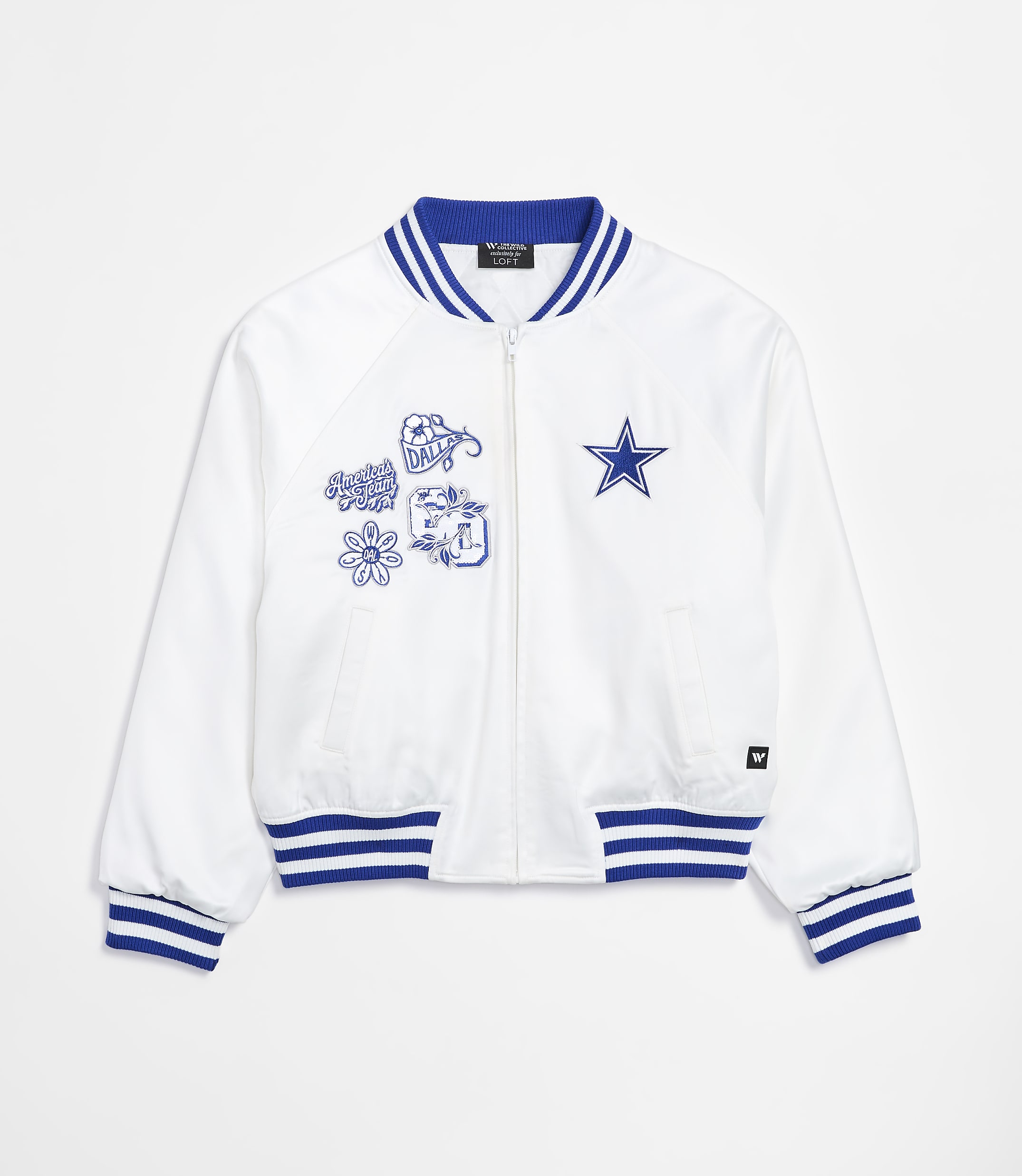A white bomber jacket with blue trim and embroidered patches is displayed against a plain white background.