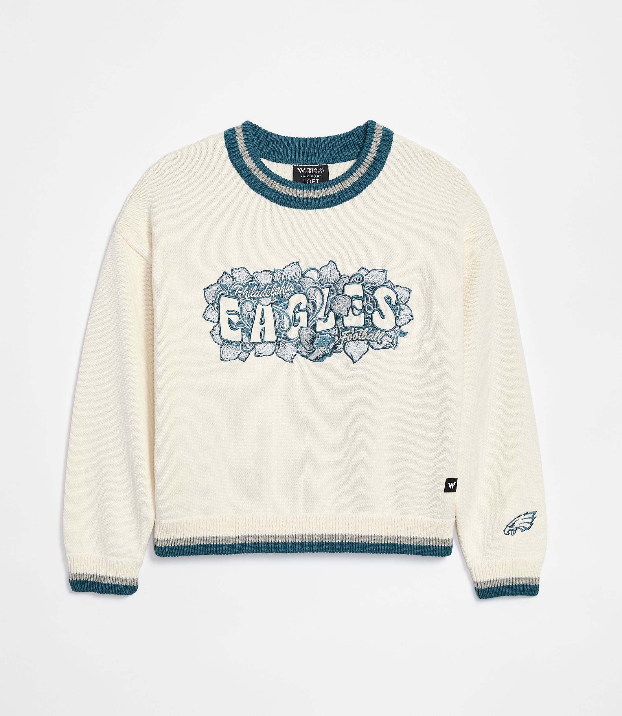 A cream-colored sweater with "Philadelphia Eagles" emblazoned across the chest in teal and gray lettering is displayed against a plain white background.