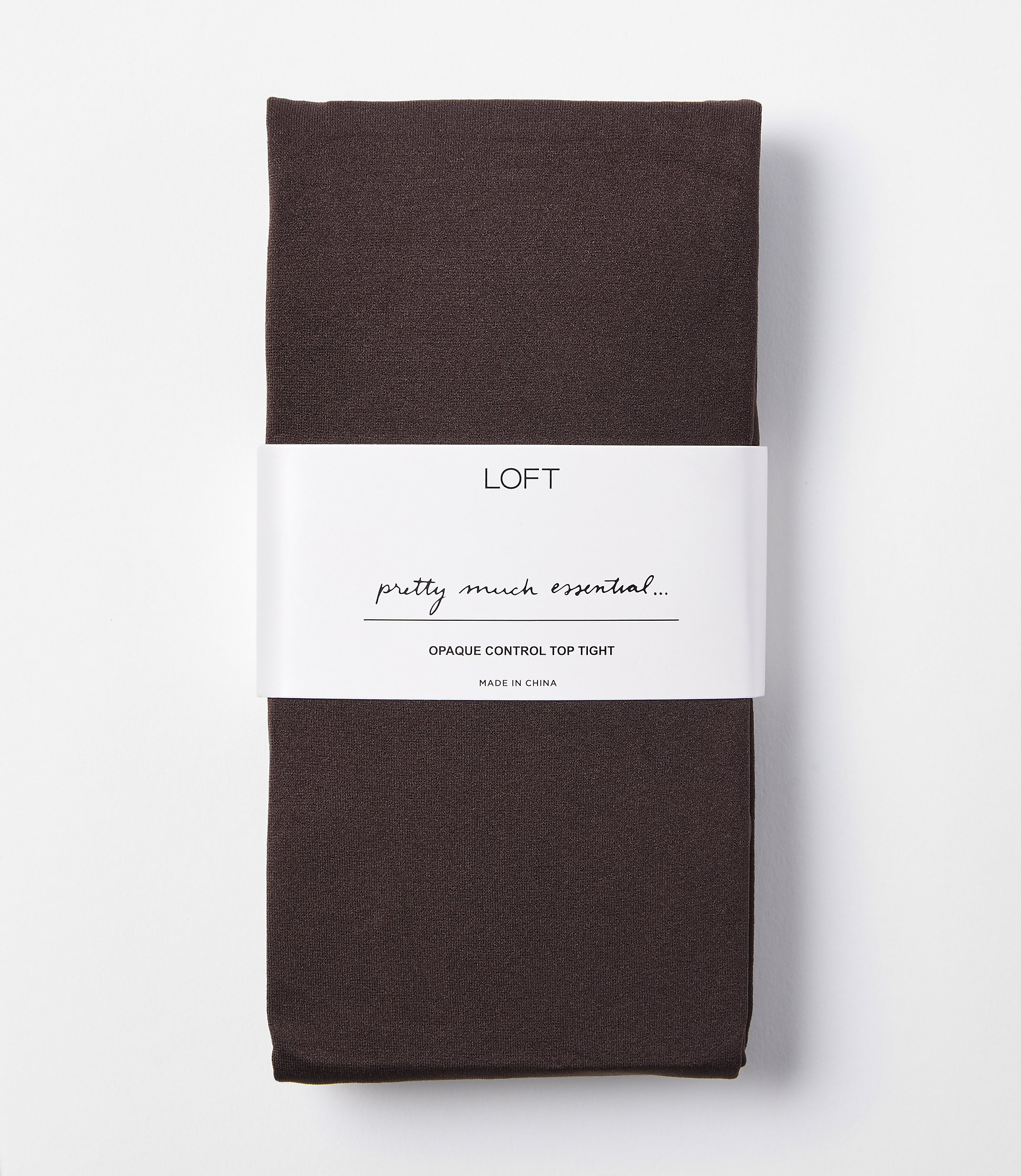 A pair of dark brown opaque control top tights are folded and banded with a white label that reads "LOFT pretty much essential... OPAQUE CONTROL TOP TIGHT" against a plain white background.
